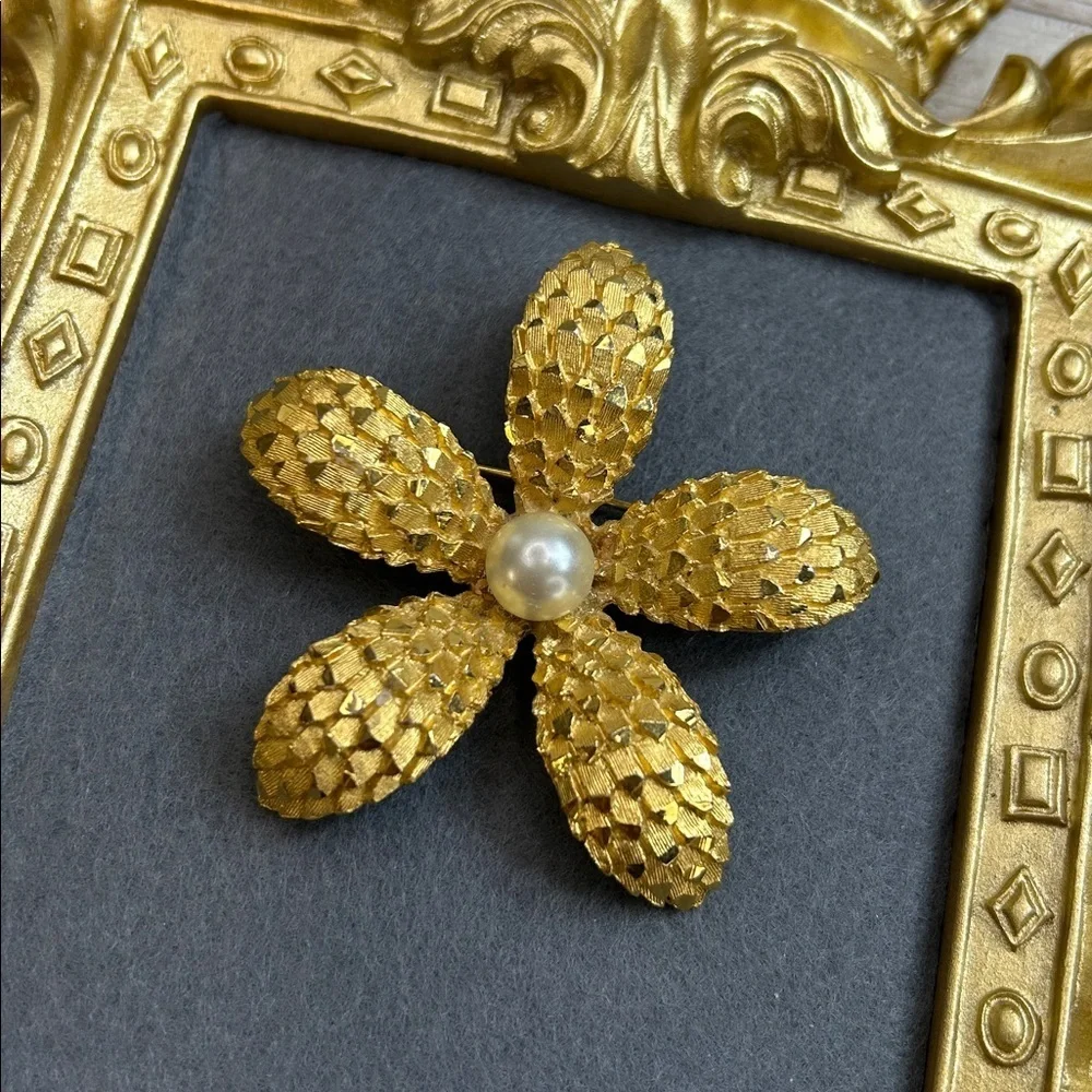 Vintage BSK gold-tone textured flower brooch with a faux pearl center.
